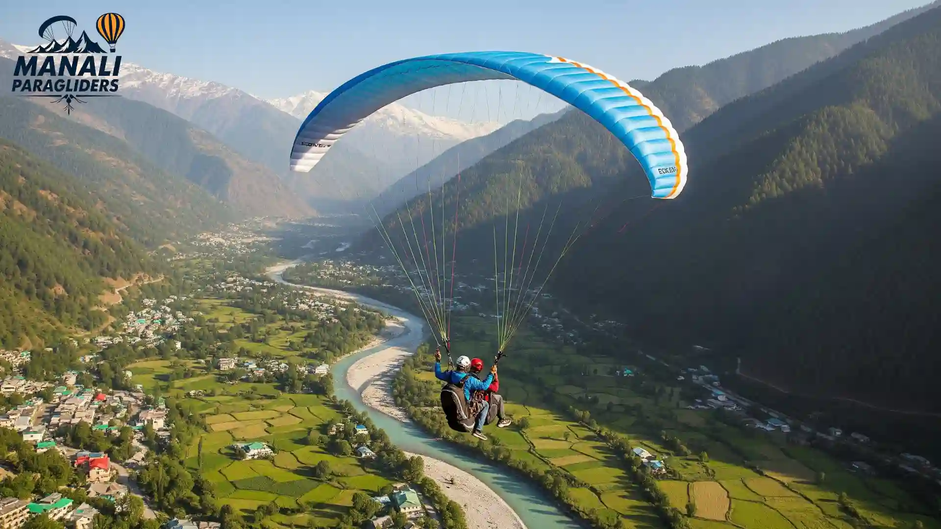 Tandem paragliding flight with Kullu Manali Paragliders over the Beas River and green valleys towards snowy Himalayan peaks.